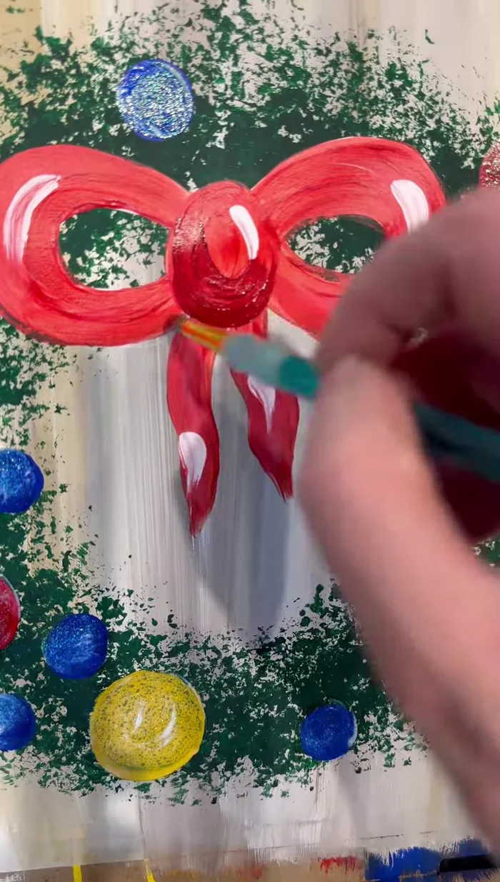 Use a detail brush and white paint to add squiggly lines resembling tinsel or streamers for extra festiveness. Add half-C shapes to the ornaments for shine.