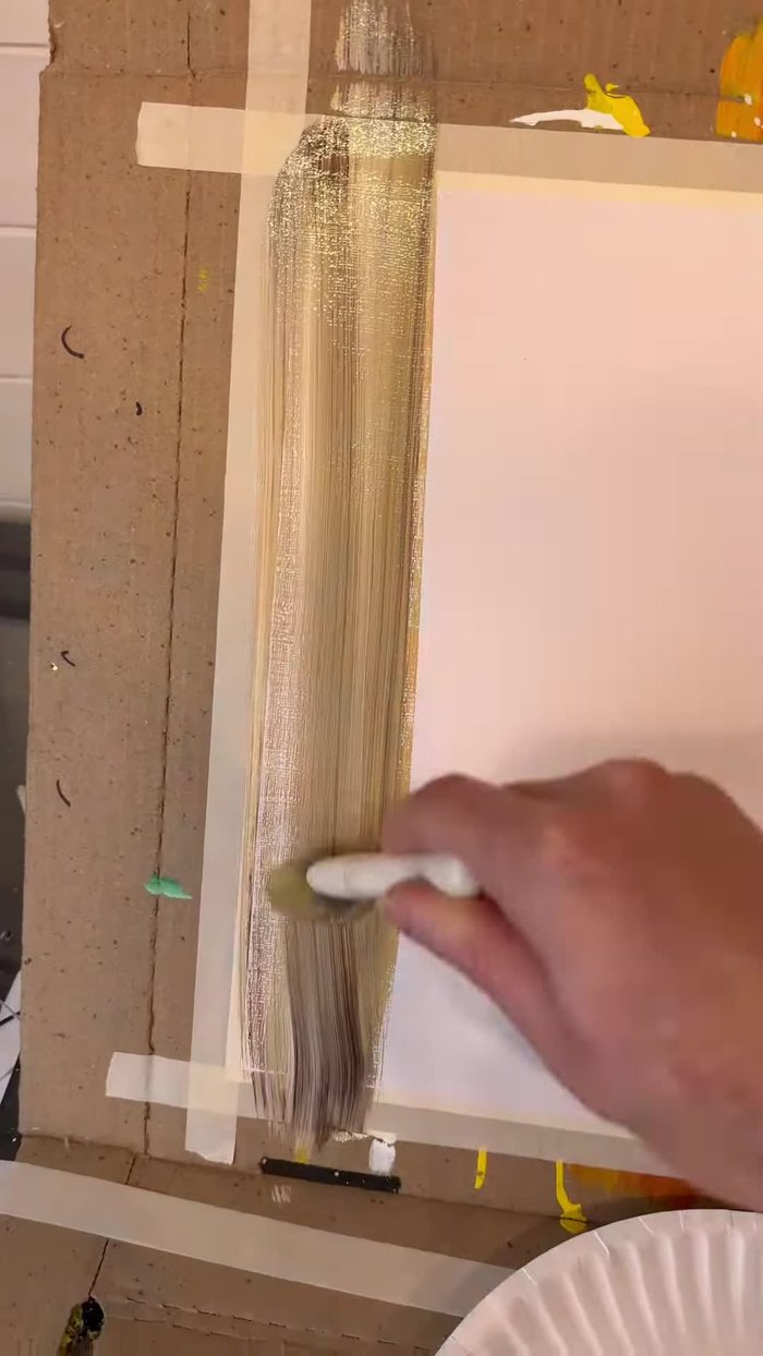 Dry the base. Then, use a sea sponge with Christmas green and darker green paints to create the wreath shape by bouncing the sponge in a circular motion.