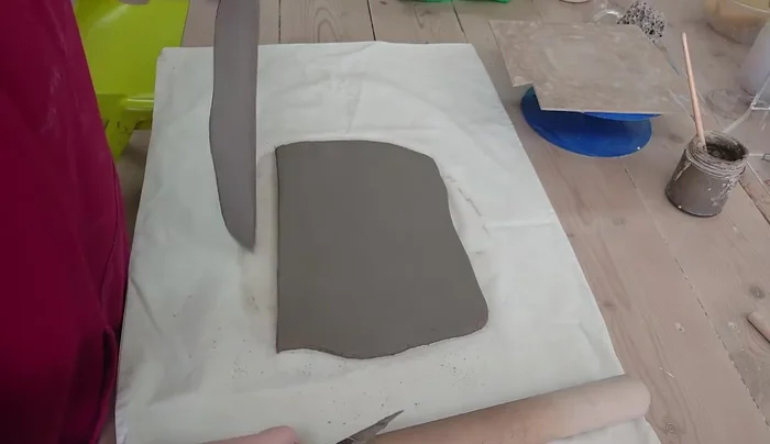 Trim a piece of clay for the mushroom base, creating a slightly wider circle than the height of the mushroom.
