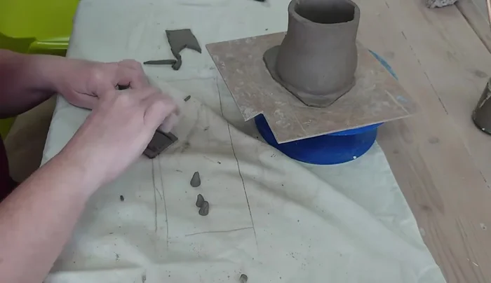 Add details like windows using cutting tools. Clean up excess clay as needed.
