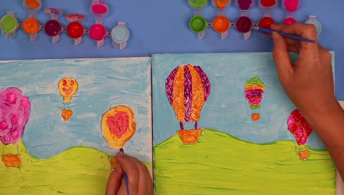 Add tethers connecting the balloons to their baskets, using any color you prefer.