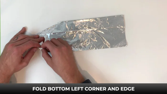 Fold the bottom left corner and edge up to the line. Fold up the right side to the line and the top right corner down to the line. Fold the bottom section up and fold the top right corner down on both sides. Open it up.