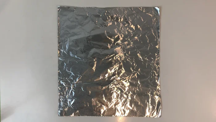 Fold one of the four pieces down to the bottom. Turn it over and fold down the rest to the bottom. Open the edges and fold down. Open it up.