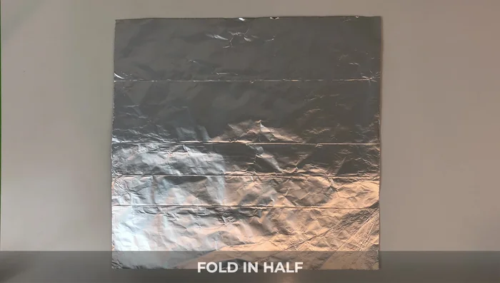 Fold down the right side to the bottom, flip it over, and fold down. Flip again and fold down. Turn it over; fold down the top left corner and edge to the line.