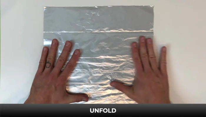 Fold down the right side to the bottom, flip it over, and fold down. Flip again and fold down. Turn it over; fold down the top left corner and edge to the line.