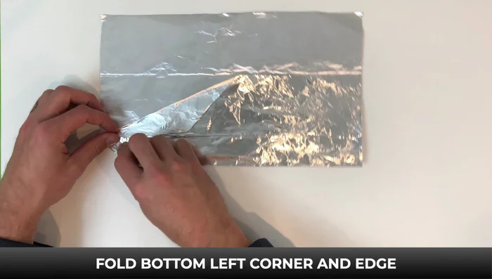 Fold down the right side to the bottom, flip it over, and fold down. Flip again and fold down. Turn it over; fold down the top left corner and edge to the line.