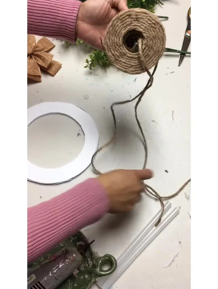 Glue the burlap bow and greenery (boxwood) to the wreath.