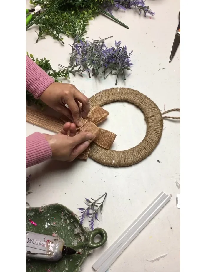 Glue the burlap bow and greenery (boxwood) to the wreath.