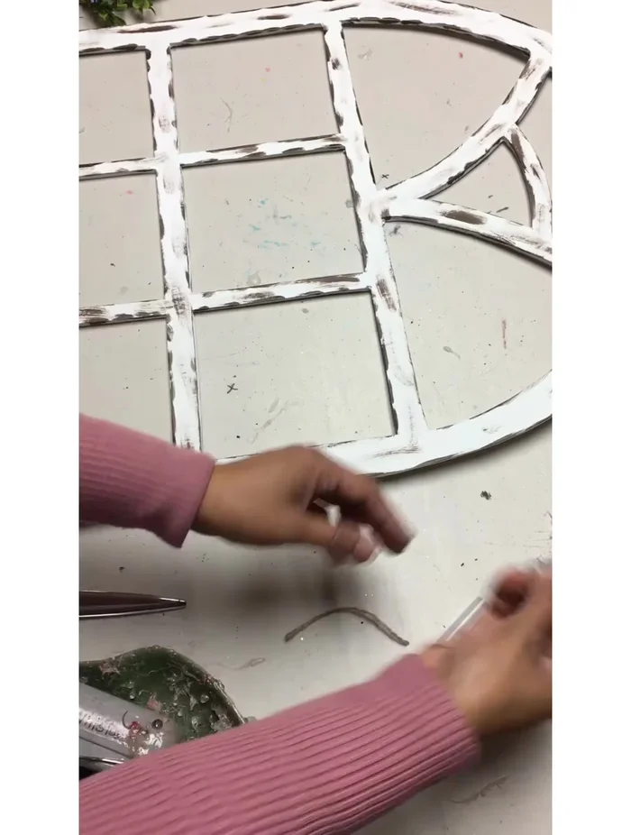 Attach the wreath and wooden sign (optional) to the window frame.