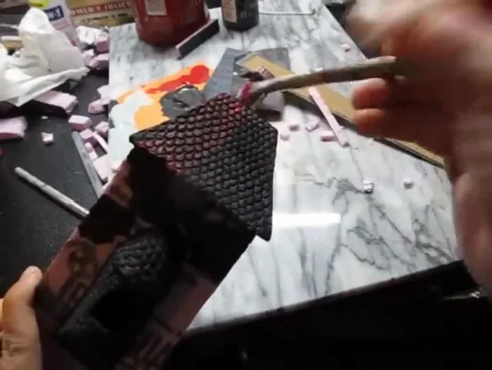 Dry brush with red paint for the roofs and gray for the walls. This technique highlights the texture and creates a realistic look. Use a dry brush with little paint on it; lightly brush over the surfaces.