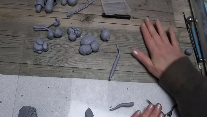 Make a worm: Add clay to floral wire, create a slightly larger head, add rings, and bend into shape.