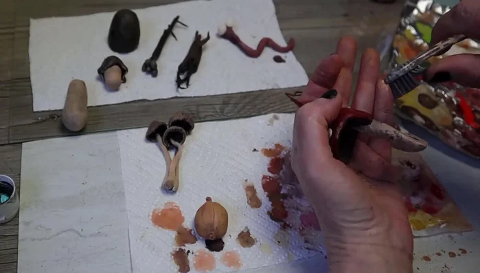 Add speckles using a toothbrush. Add a layer of resin to make them waterproof.