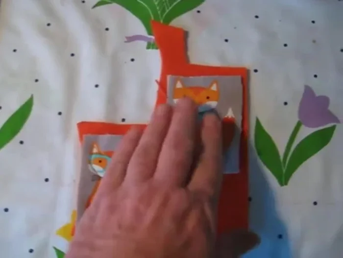 Carefully cut around the outer edge of the finished piece, trimming close to the stitching but not cutting the stitching itself.