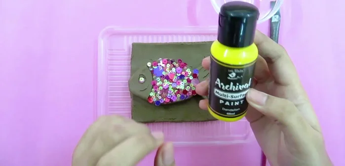 Paint the dried clay fish.