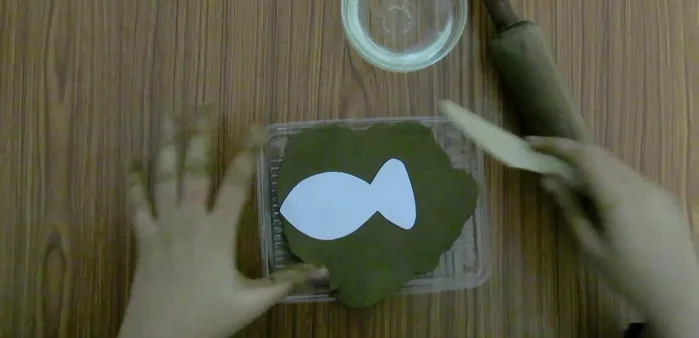 Place fish cut out on the clay and cut around it.