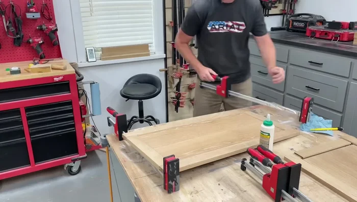 Resquare legs after glue-up. Add dowels and glue to join the panels to the legs.