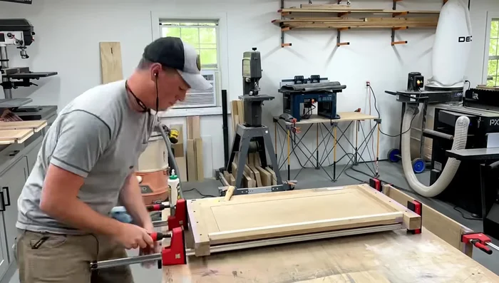 Add glue and dowels to attach the bottom panel, using tape to prevent glue squeeze-out.