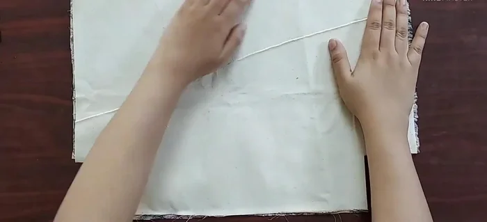 Attach interfacing to main fabric: Place interfacing on the wrong side of the main fabric and stitch around the edges.