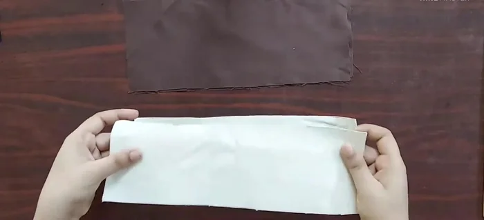 Make handles: Cut two rectangular pieces of fabric (5 inches x 12 inches) and interfacing (4 inches x 12 inches). Attach interfacing to fabric, fold inwards, and stitch.