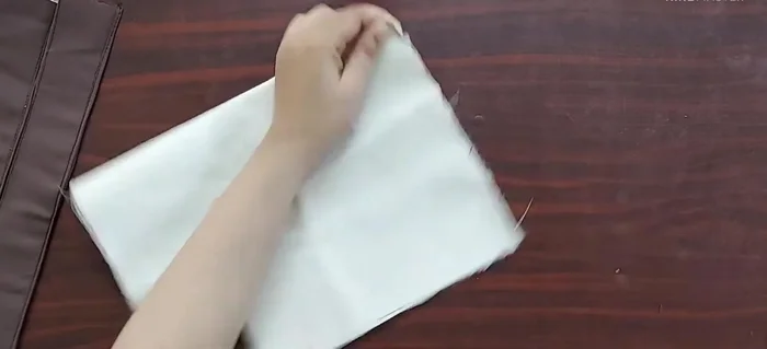 Attach handles to main fabric panels: Mark points 1 inch from center on the main fabric, place handles 2 inches apart, and stitch.