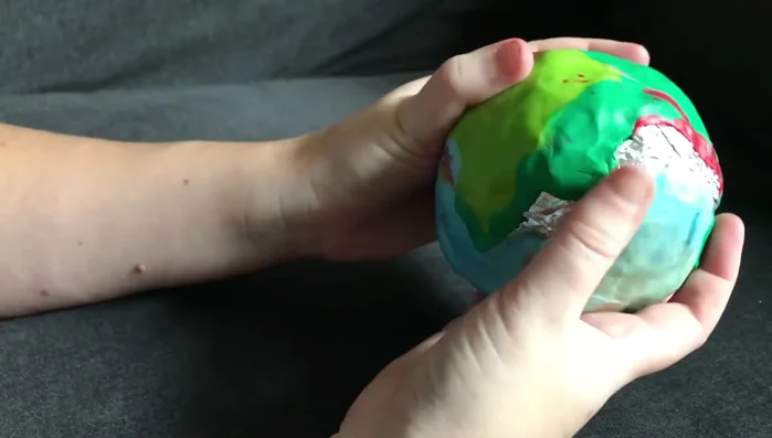 Smooth out the clay surface using your fingers to fill gaps and create a more uniform shape. Add more clay as necessary.