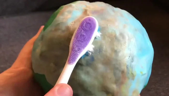 Use a ball tool (or similar sculpting tool) to create additional indentations and craters for added realism.