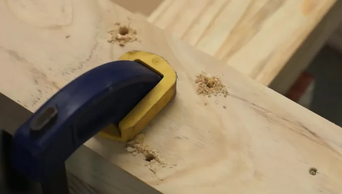 Drill holes for the axle, ensuring they are perfectly vertical.