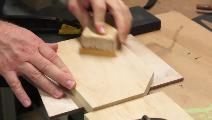 Apply pre-stain conditioner and multiple coats of walnut stain, followed by gloss clear coat.