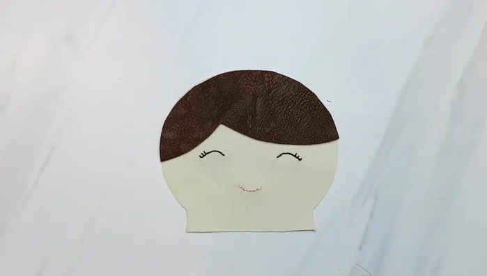 Sew the hair piece to the front of the doll head, along the hairline using a 1/8 inch seam allowance.