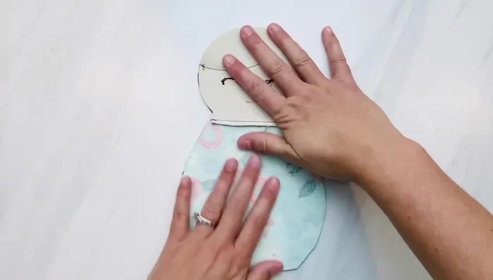 Place the front and back pieces of the doll together, right sides facing in. Pin and sew around the entire doll, leaving the opening at the back.