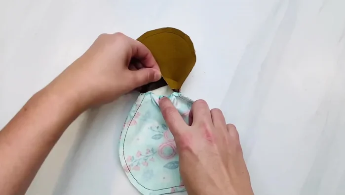 Stuff the doll firmly with polyester fiber fill, paying attention to curves to avoid puckering.