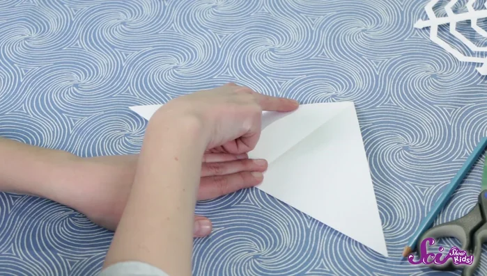 Flip the paper over and repeat step 2 on the other side, making sure to use the crease as a guide.