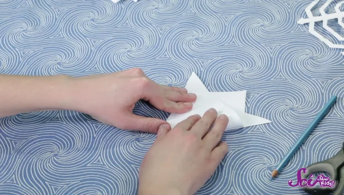 Flip the paper over and repeat step 2 on the other side, making sure to use the crease as a guide.