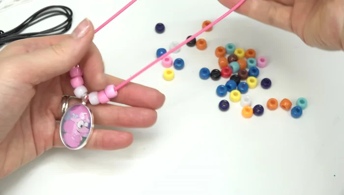 Secure the cords/elastic to complete the necklaces and bracelets.