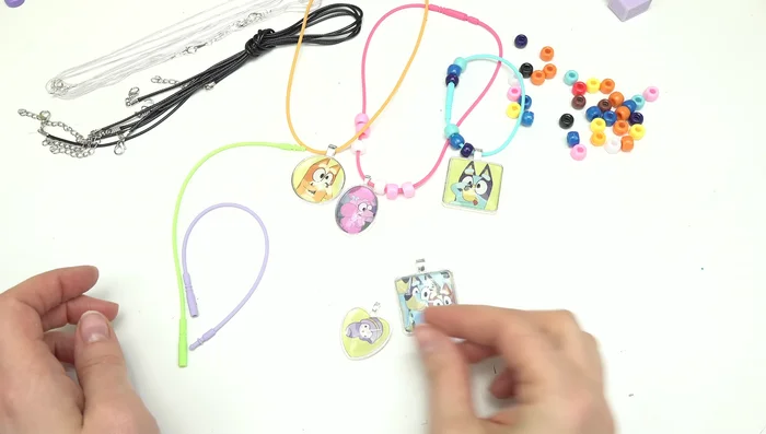 Secure the cords/elastic to complete the necklaces and bracelets.