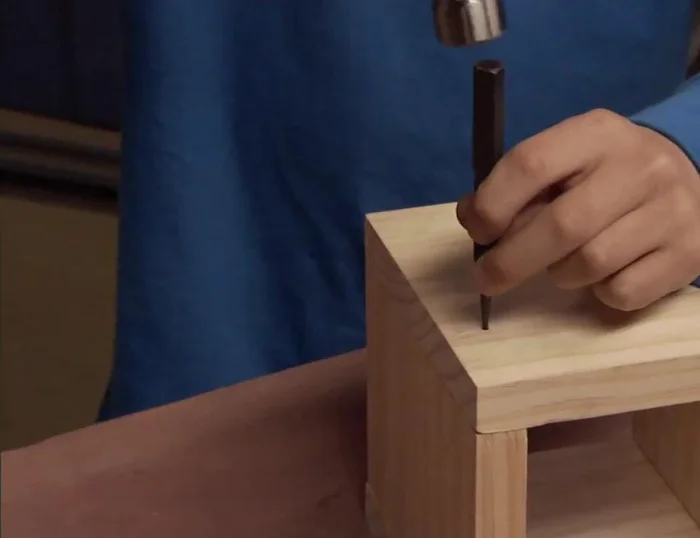 Hammer nails into the box, using a nail set to countersink them.