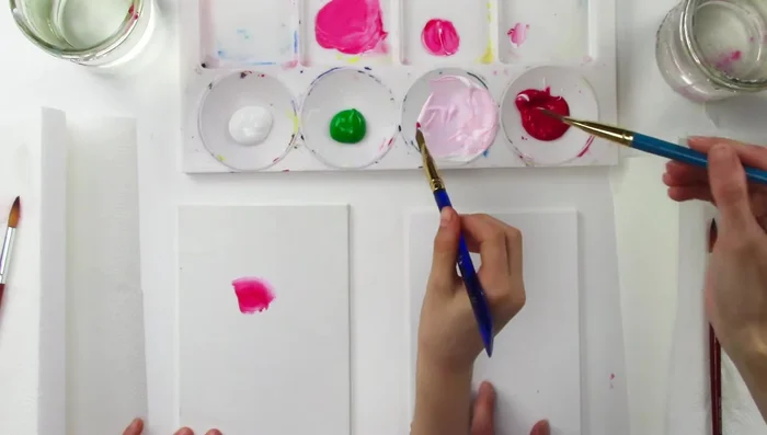 Continue adding petals using the same technique, blending red and pink, following the shape of the rose.