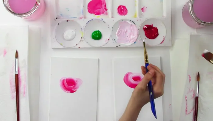 Dip your brush in white and red, then add petals to define the rose’s edges. Remember to blend the colors smoothly.