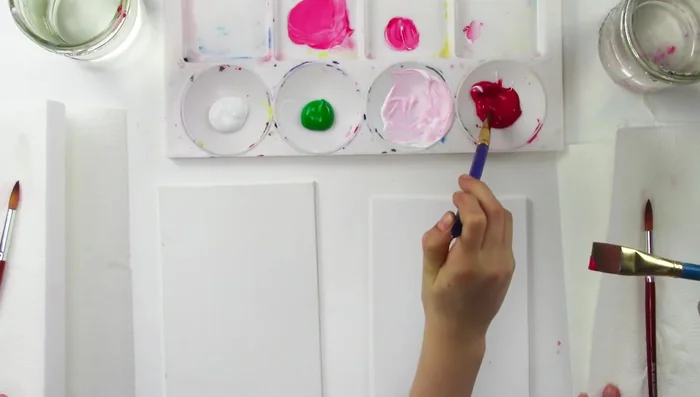 Start in the middle of your canvas, using only your fingers to twist the brush and create the rose's center. Practice this technique until you achieve a smooth, blended effect.