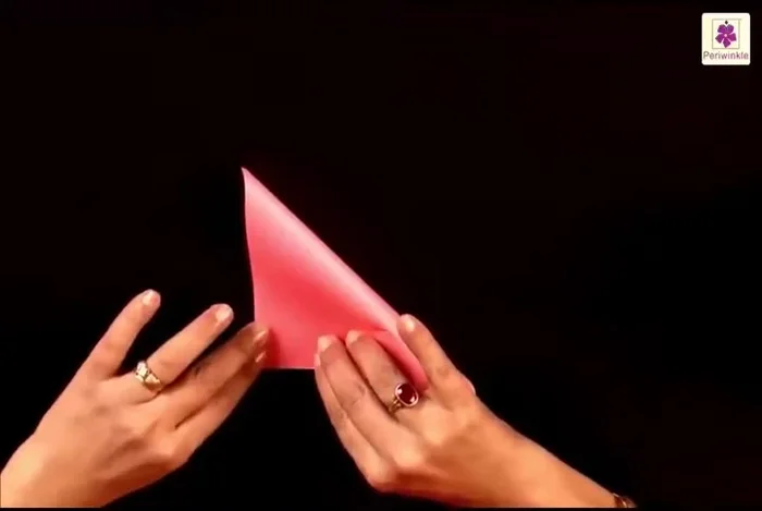 Lift the top flap from the bottom right corner and place it to the bottom left corner.