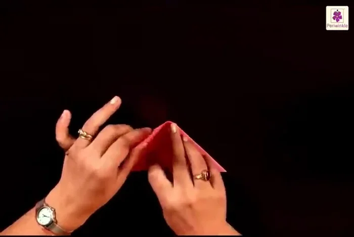 Lift the top flap from the bottom right corner and place it to the bottom left corner.