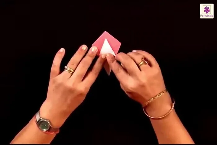 Bring the two remaining flaps downwards. Fold them on the sides, then open them slightly. Push in from inside to shape the box.