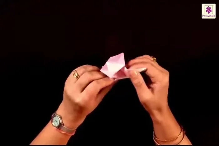 Bring the two remaining flaps downwards. Fold them on the sides, then open them slightly. Push in from inside to shape the box.