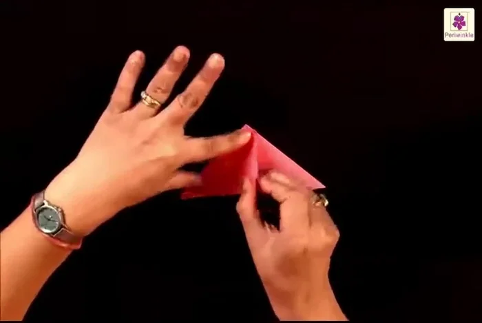 Lift the top flap from the bottom right corner and place it to the bottom left corner.