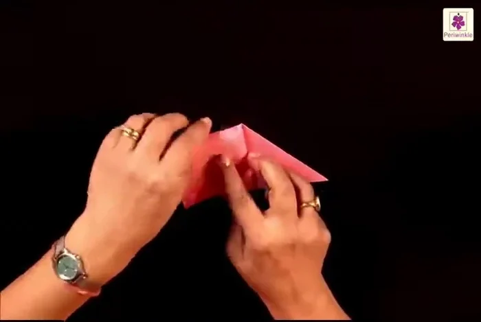 Flip it over and repeat steps 5 on the other side, creating creases first by folding the bottom left corner to the bottom right corner, pressing the fold and then folding the left side to the top right side.