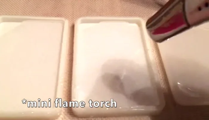 Use a flame torch or cigarette lighter to remove air bubbles from the resin.