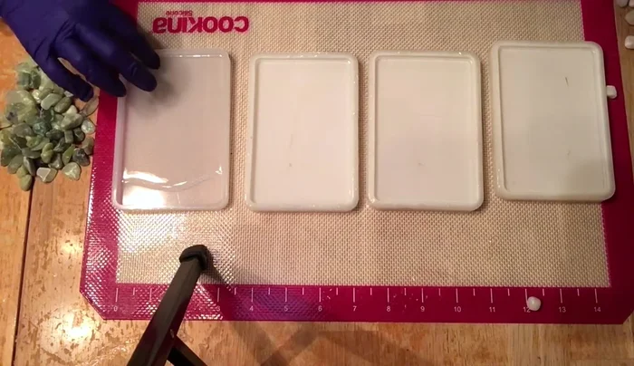 Use the flame torch again to remove any remaining bubbles after adding pebbles.