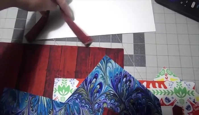 Make a handle by sewing together two 2 x 9 inch fabric pieces with foam interfacing inside, turning inside out and topstitching.