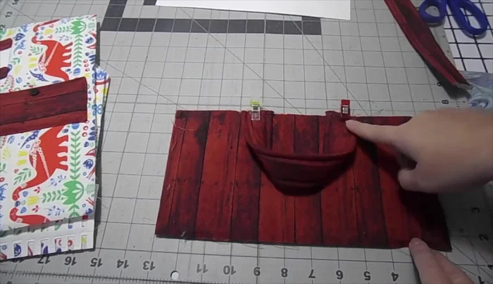 Attach the handle to the roof. Sew the roof to the front piece, leaving the bottom open for the flap.