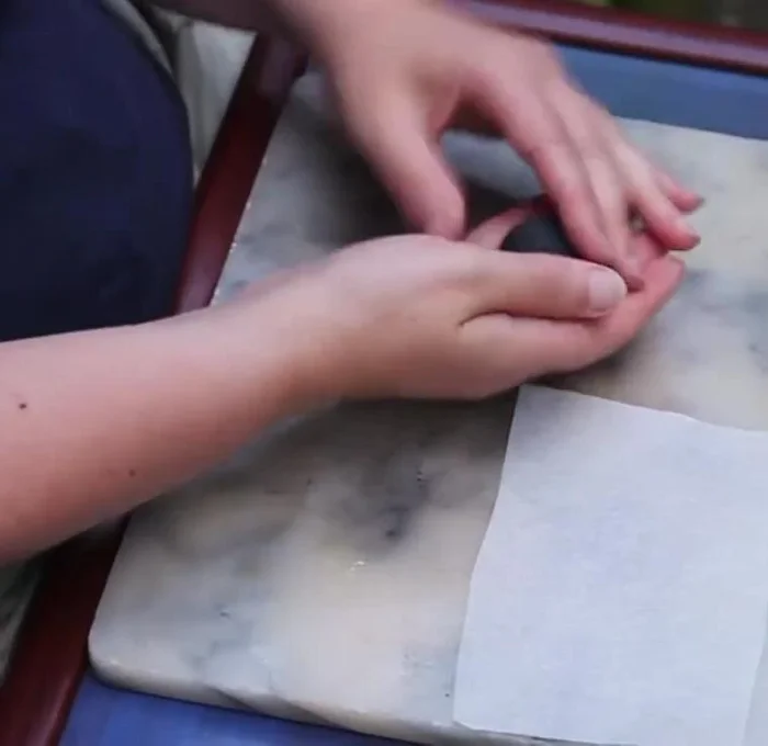 Prepare the yellow clay by rolling it into a small sausage, then cut it in half.